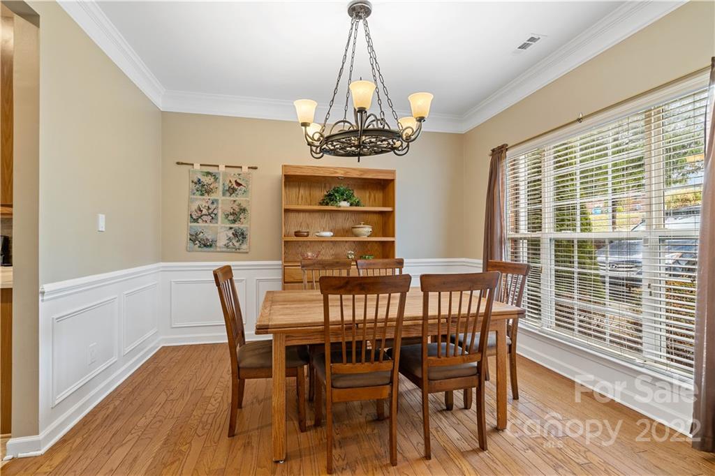 5677 Berry Ridge Drive Harrisburg, NC 28075 - Photo 11 of 24 a view of a dining room with furniture window and wooden floor
