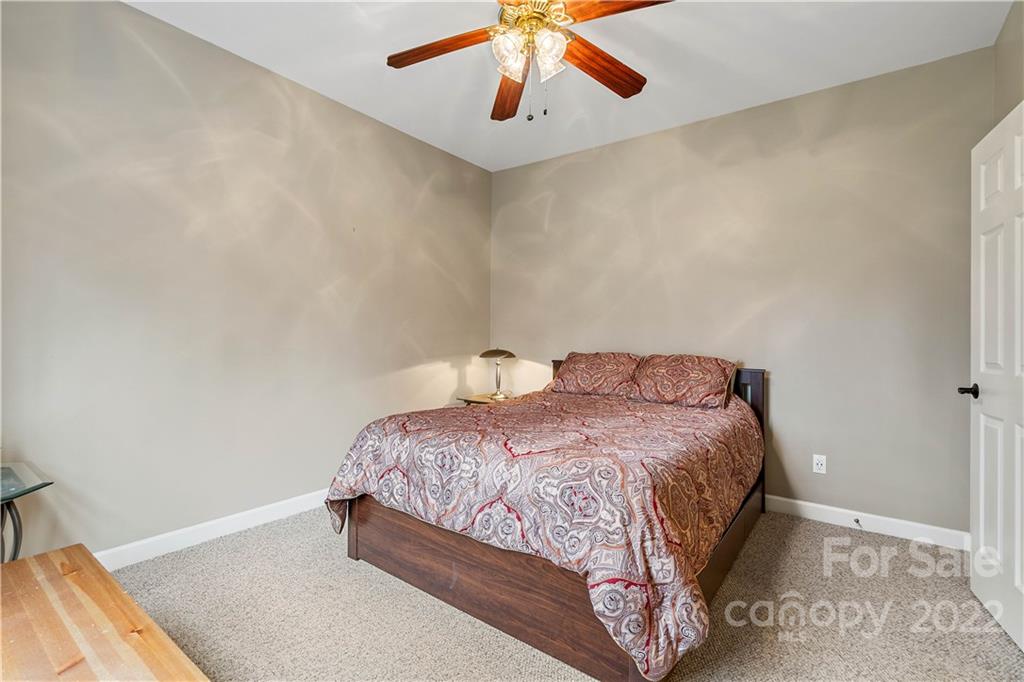 5677 Berry Ridge Drive Harrisburg, NC 28075 - Photo 13 of 24 a bedroom with a bed and window