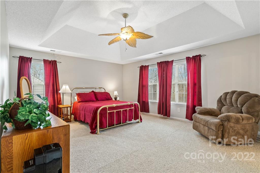 5677 Berry Ridge Drive Harrisburg, NC 28075 - Photo 15 of 24 a living room with furniture and a chandelier