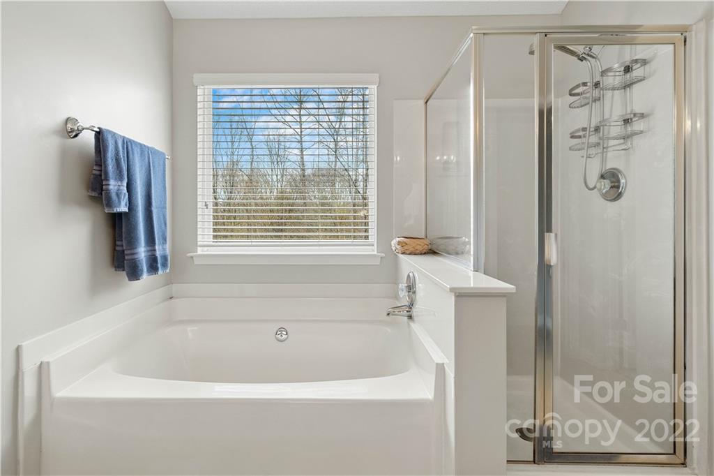 5677 Berry Ridge Drive Harrisburg, NC 28075 - Photo 17 of 24 a white bath tub sitting next to a shower
