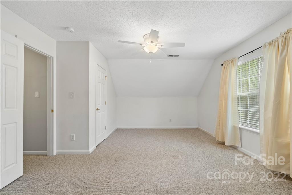 5677 Berry Ridge Drive Harrisburg, NC 28075 - Photo 20 of 24 an empty room with chandelier fan