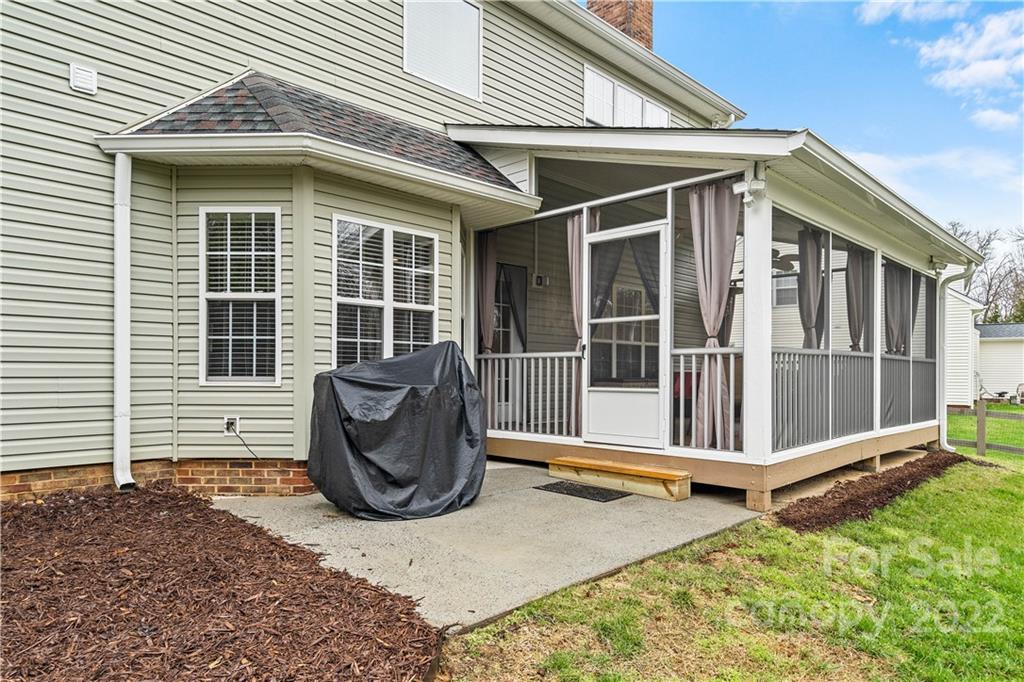 5677 Berry Ridge Drive Harrisburg, NC 28075 - Photo 24 of 24 a view of a house with a floor to ceiling window and potted plants