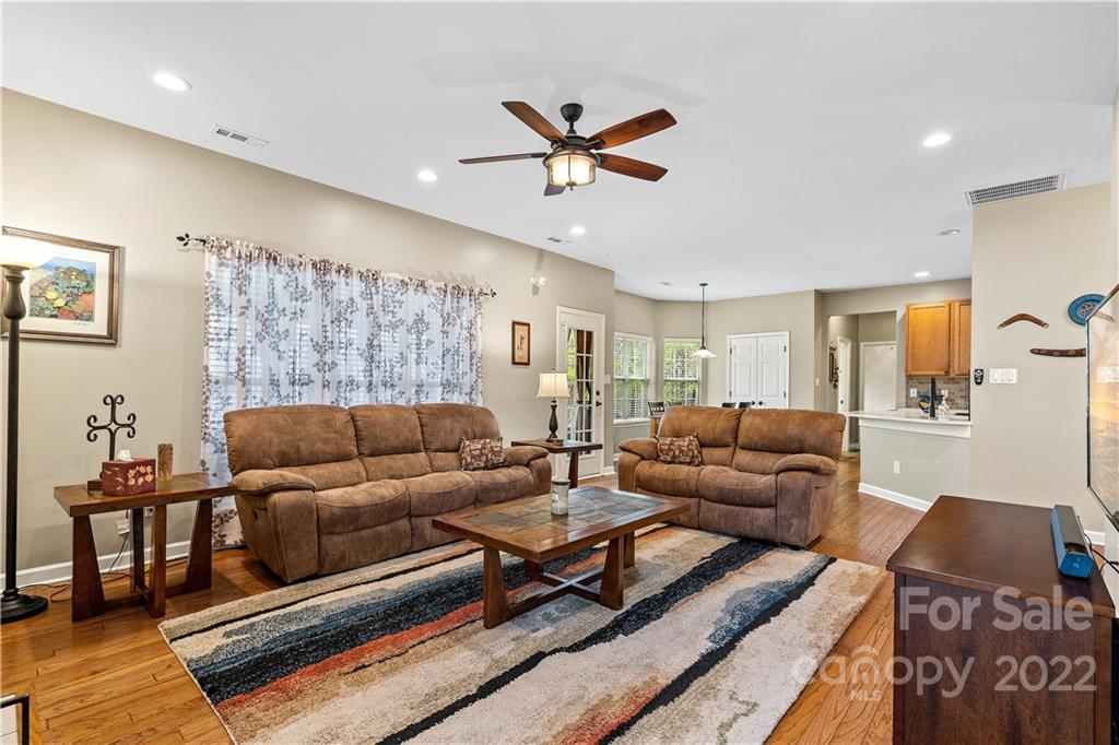 5677 Berry Ridge Drive Harrisburg, NC 28075 - Photo 3 of 24 a living room with furniture and a wooden floor