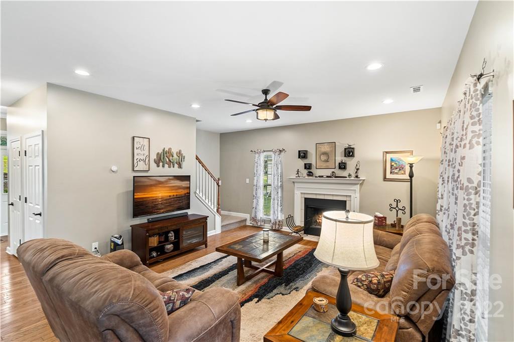 5677 Berry Ridge Drive Harrisburg, NC 28075 - Photo 5 of 24 a living room with furniture and a flat screen tv with kitchen view