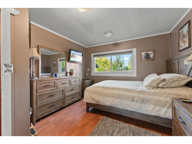 a bedroom with a large bed and a dresser