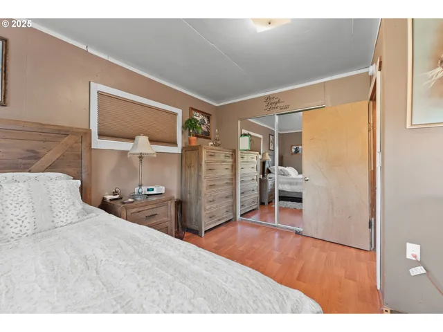 a bedroom with a bed and a flat tv screen