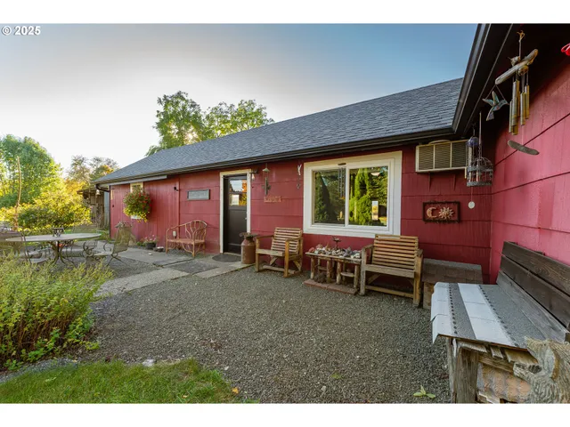 a view of a house with a chairs and table in a patio