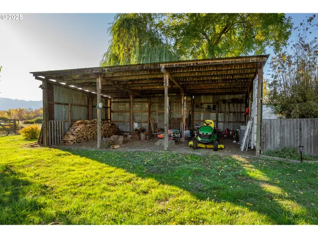 a view of a field with grass and trees