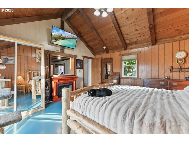 a bedroom with a bed next to a window