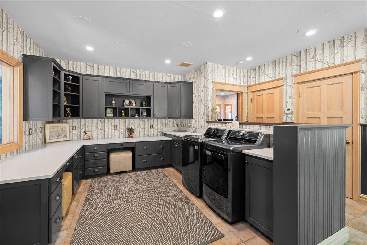 500 Ashland Loop Road Ashland, OR 97520 - Photo 22 of 67 a kitchen with stainless steel appliances granite countertop a refrigerator a sink dishwasher a stove and white countertops with wooden floor