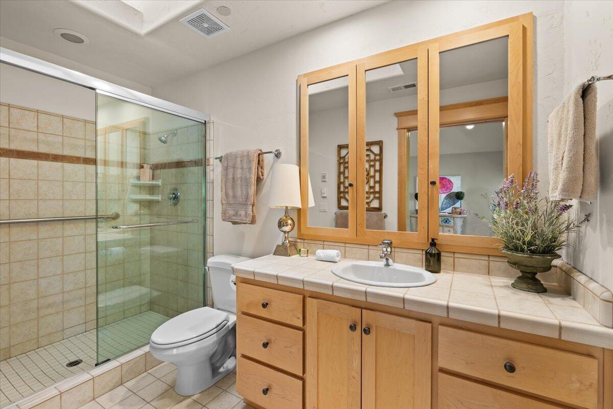 500 Ashland Loop Road Ashland, OR 97520 - Photo 43 of 67 a bathroom with a granite countertop sink a toilet and shower