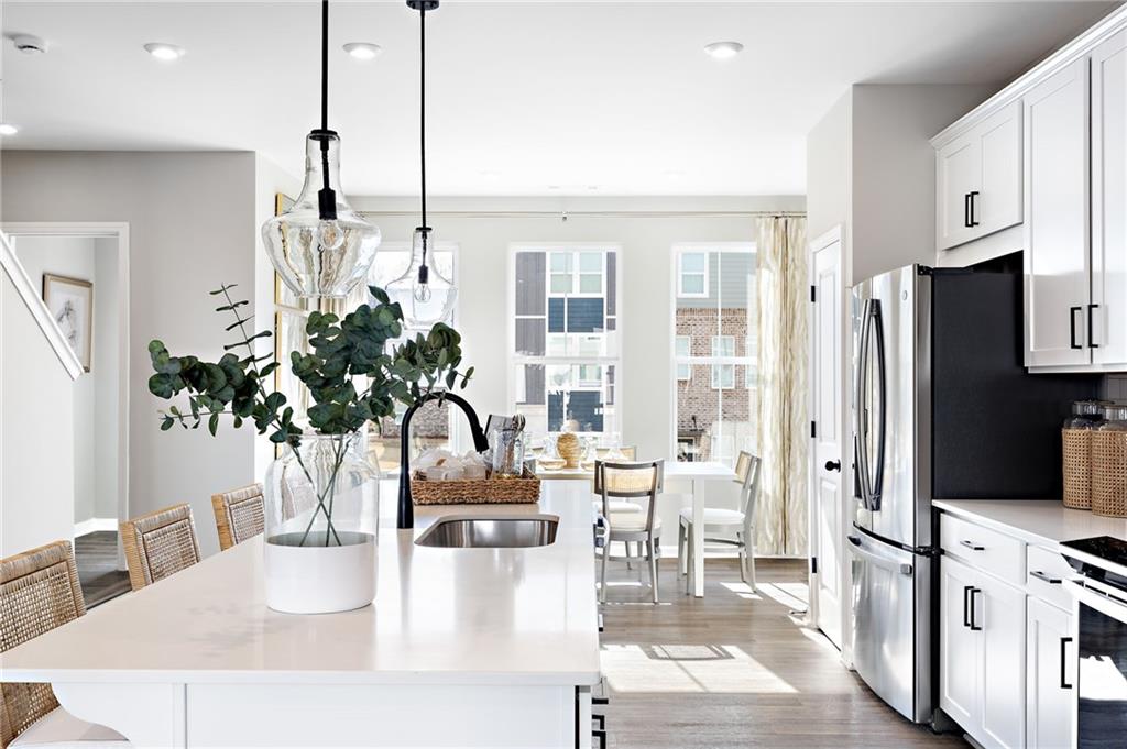 801 Cameron Trail Acworth, GA 30102 - Photo 13 of 36 a kitchen with stainless steel appliances kitchen island granite countertop a refrigerator a stove a sink and white cabinets