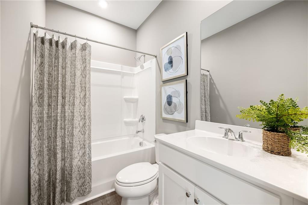 801 Cameron Trail Acworth, GA 30102 - Photo 28 of 36 a bathroom with a granite countertop sink a toilet and shower