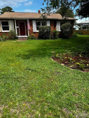 a front view of a house with a garden