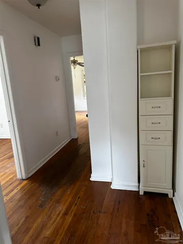 a kitchen with granite countertop a stove a refrigerator a sink a counter top space and cabinets