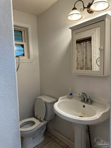 a bathroom with a sink mirror and toilet