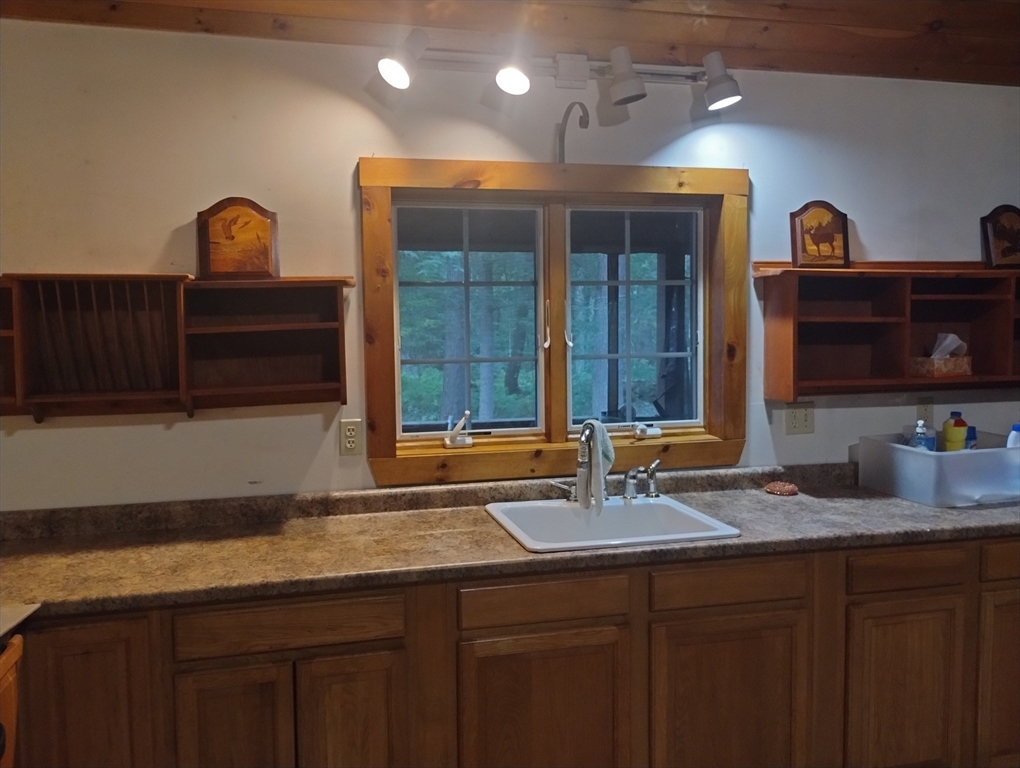 115 Town Farm Road Orange, MA 01364 - Photo 6 of 13 a sink with granite countertop a sink and a wooden cabinets