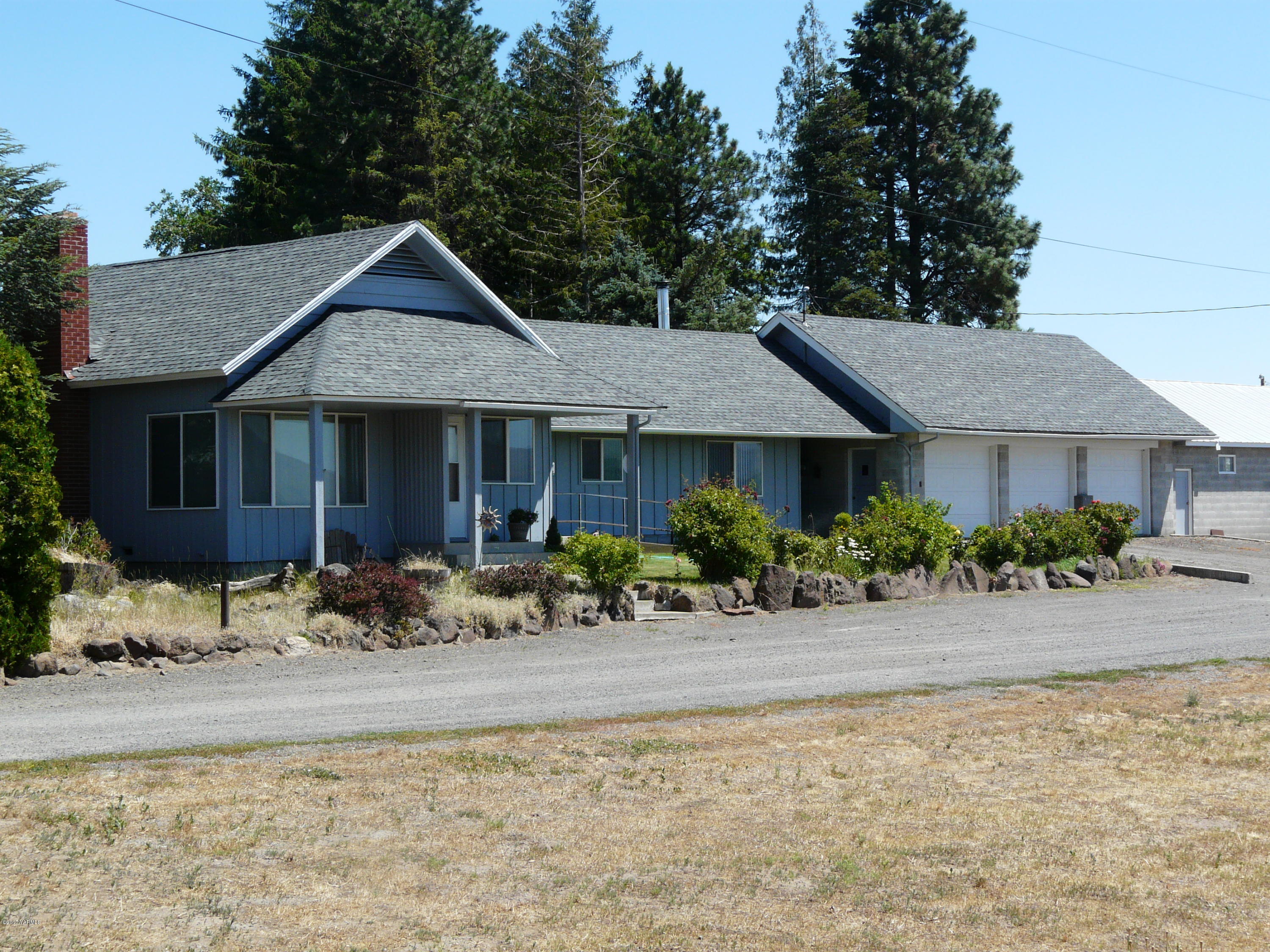 1200 Rosenkranz Road Tieton, WA 98947 - Photo 1 of 17 a front view of a house with a yard and potted plants