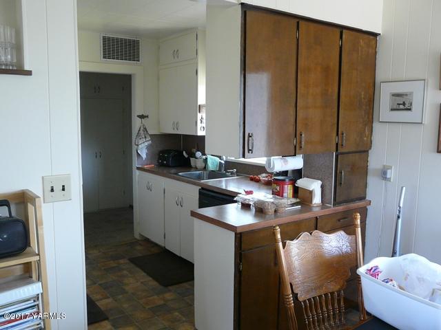 1200 Rosenkranz Road Tieton, WA 98947 - Photo 8 of 17 a kitchen with stainless steel appliances granite countertop a sink stove and refrigerator