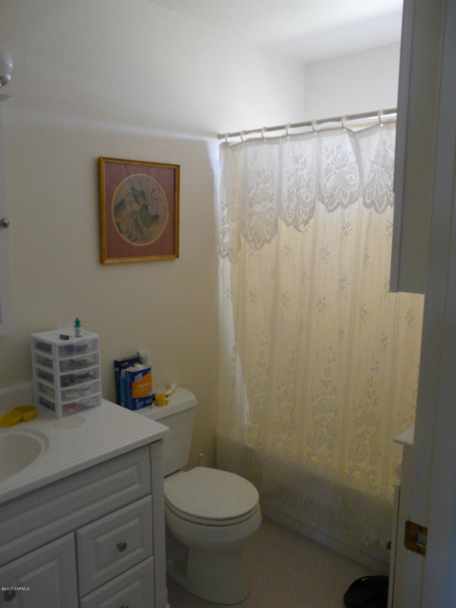 1200 Rosenkranz Road Tieton, WA 98947 - Photo 9 of 17 a bathroom with a toilet and shower curtain