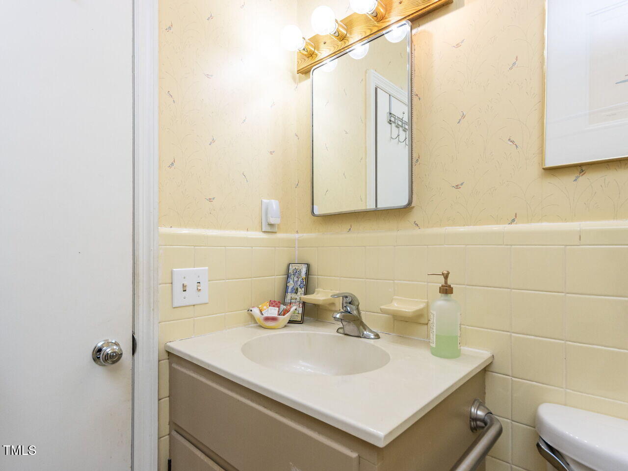 713 Macon Place Raleigh, NC 27609 - Photo 24 of 36 a bathroom with a sink toilet and mirror