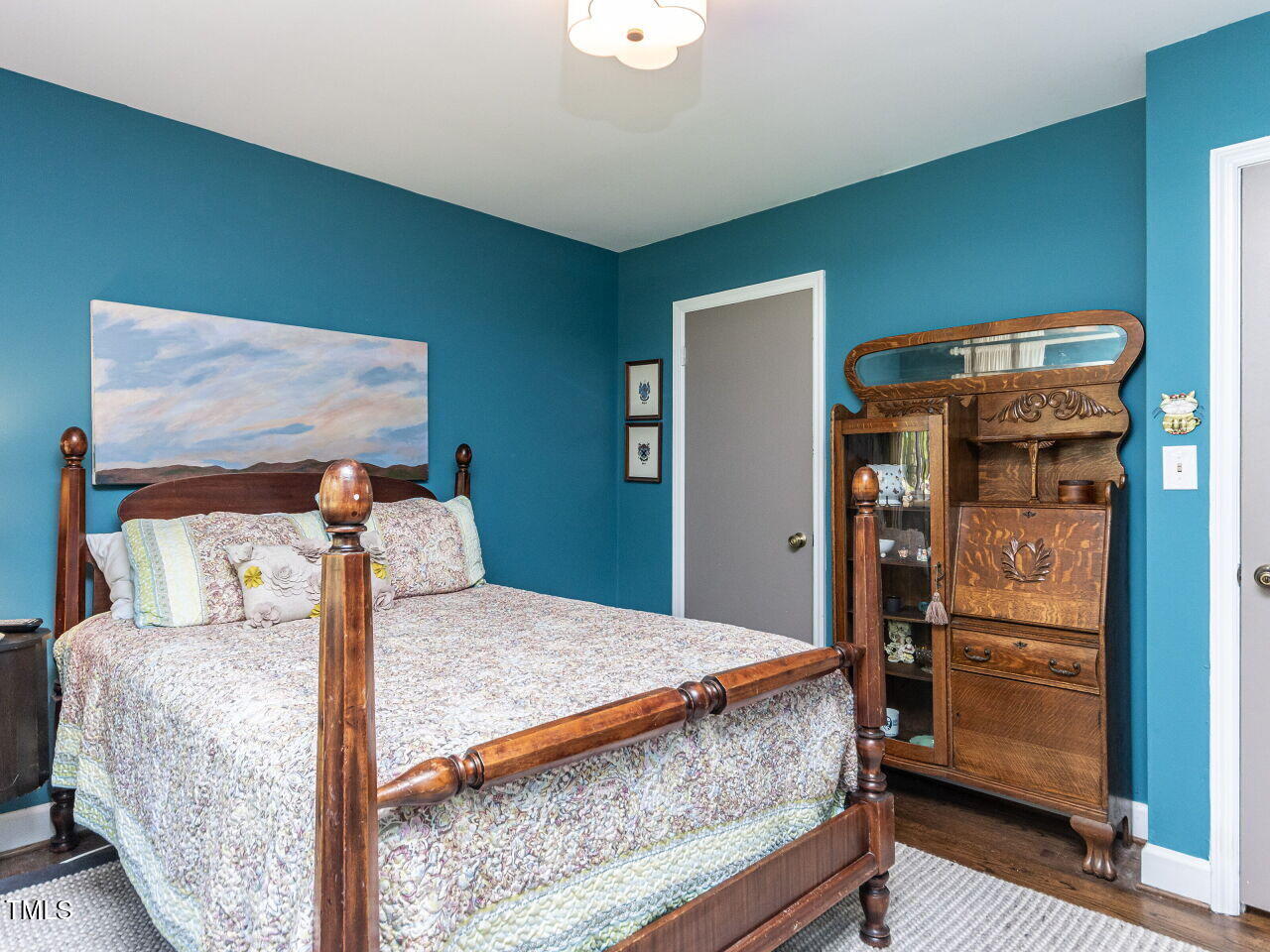 713 Macon Place Raleigh, NC 27609 - Photo 27 of 36 a bedroom with a bed and wooden floor