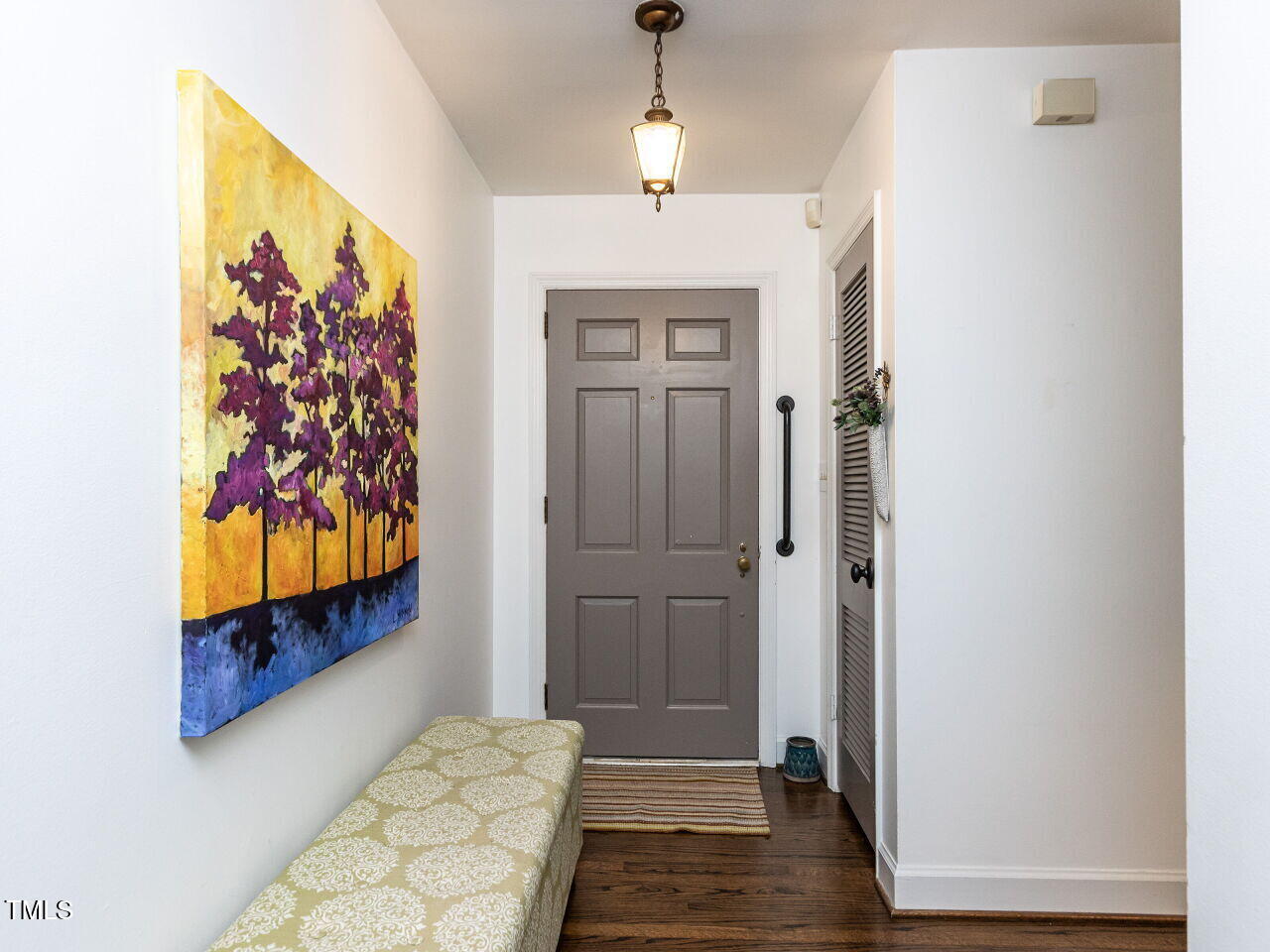 713 Macon Place Raleigh, NC 27609 - Photo 4 of 36 a view of a hallway to a bedroom with wooden floor and closet