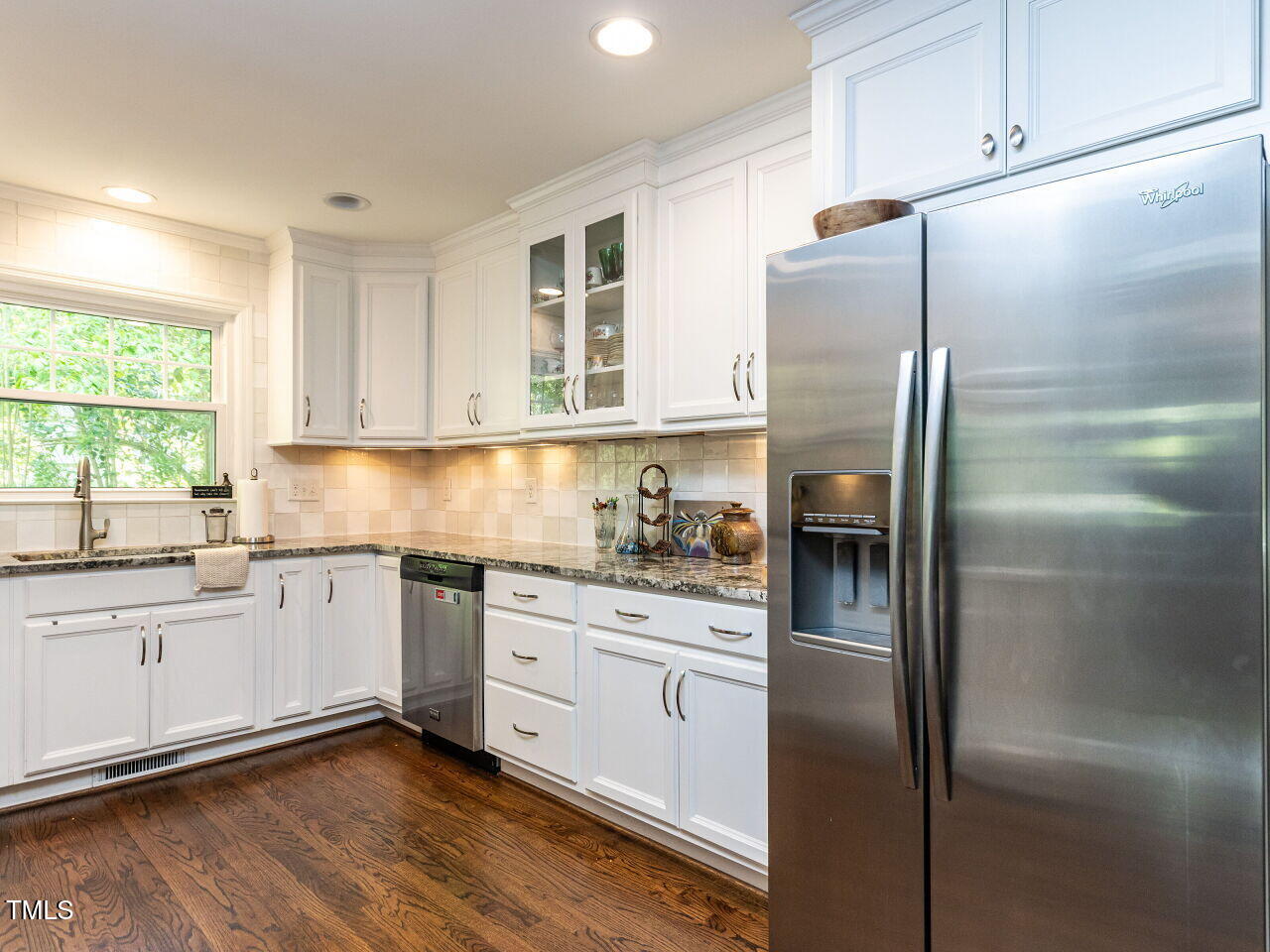 713 Macon Place Raleigh, NC 27609 - Photo 10 of 36 a kitchen with stainless steel appliances cabinets a sink and a window