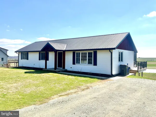 a house with swimming pool in front of it