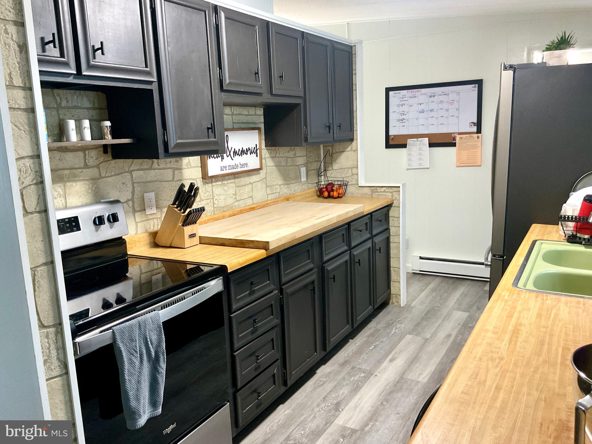 971 Dry Wells Road Quarryville, PA 17566 - Photo 25 of 37 a kitchen with stainless steel appliances a stove a sink a refrigerator and cabinets