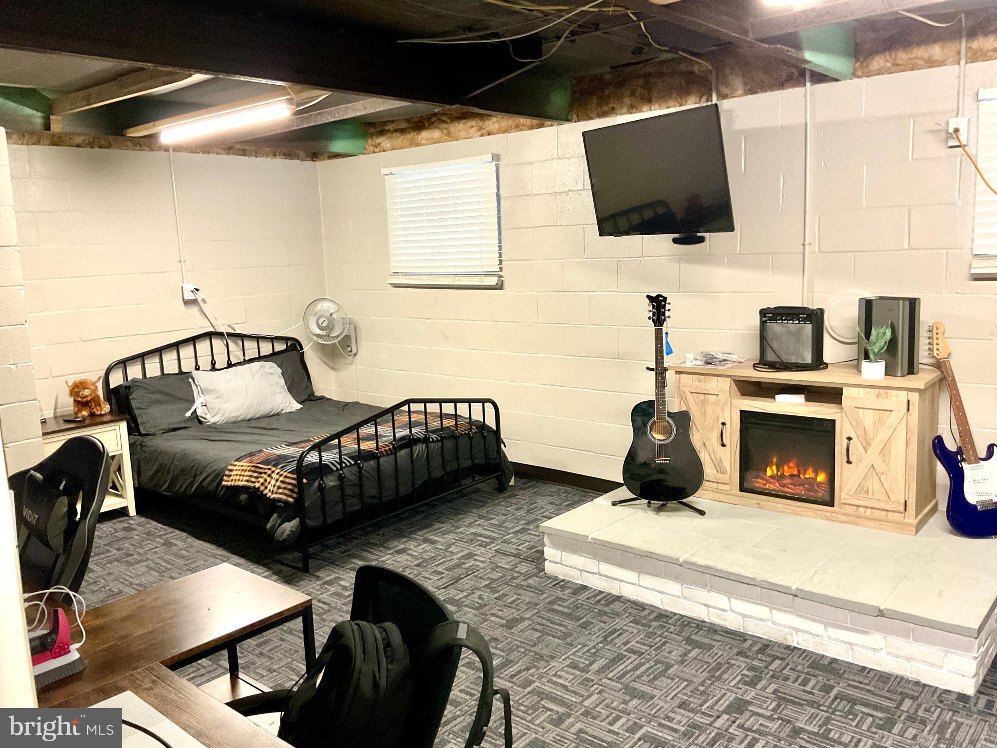 971 Dry Wells Road Quarryville, PA 17566 - Photo 36 of 37 a bedroom with a bed a flat screen tv and a couch