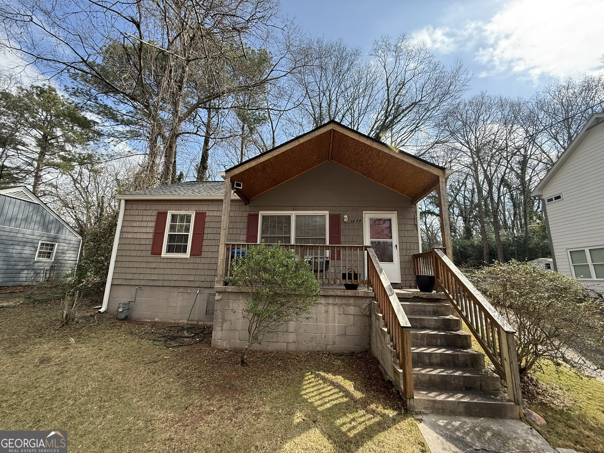 1624 Terry Mill Road Southeast Atlanta, GA 30316 - Photo 1 of 13 a front view of house with yard and trees in the background