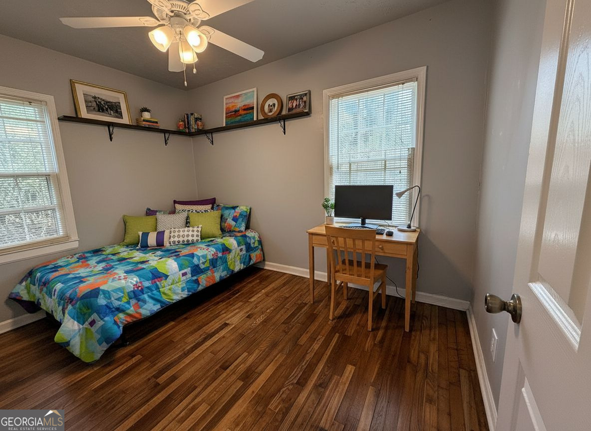 1624 Terry Mill Road Southeast Atlanta, GA 30316 - Photo 11 of 13 a bedroom with a bed and wooden floor