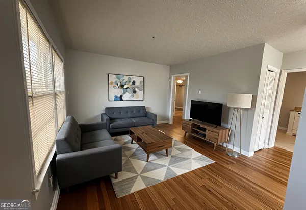 a view of a dining room with furniture and wooden floor