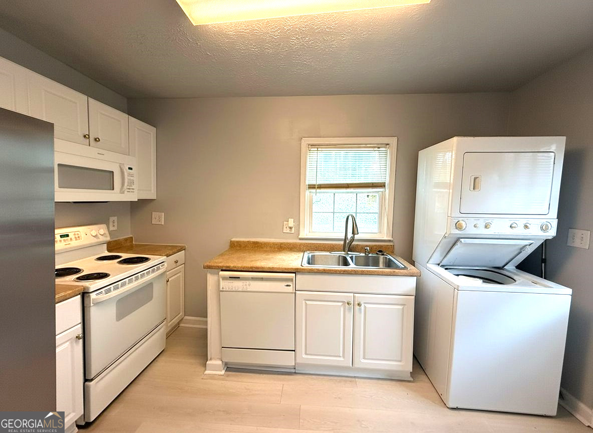 1624 Terry Mill Road Southeast Atlanta, GA 30316 - Photo 5 of 13 a kitchen with a stove top oven sink and cabinets