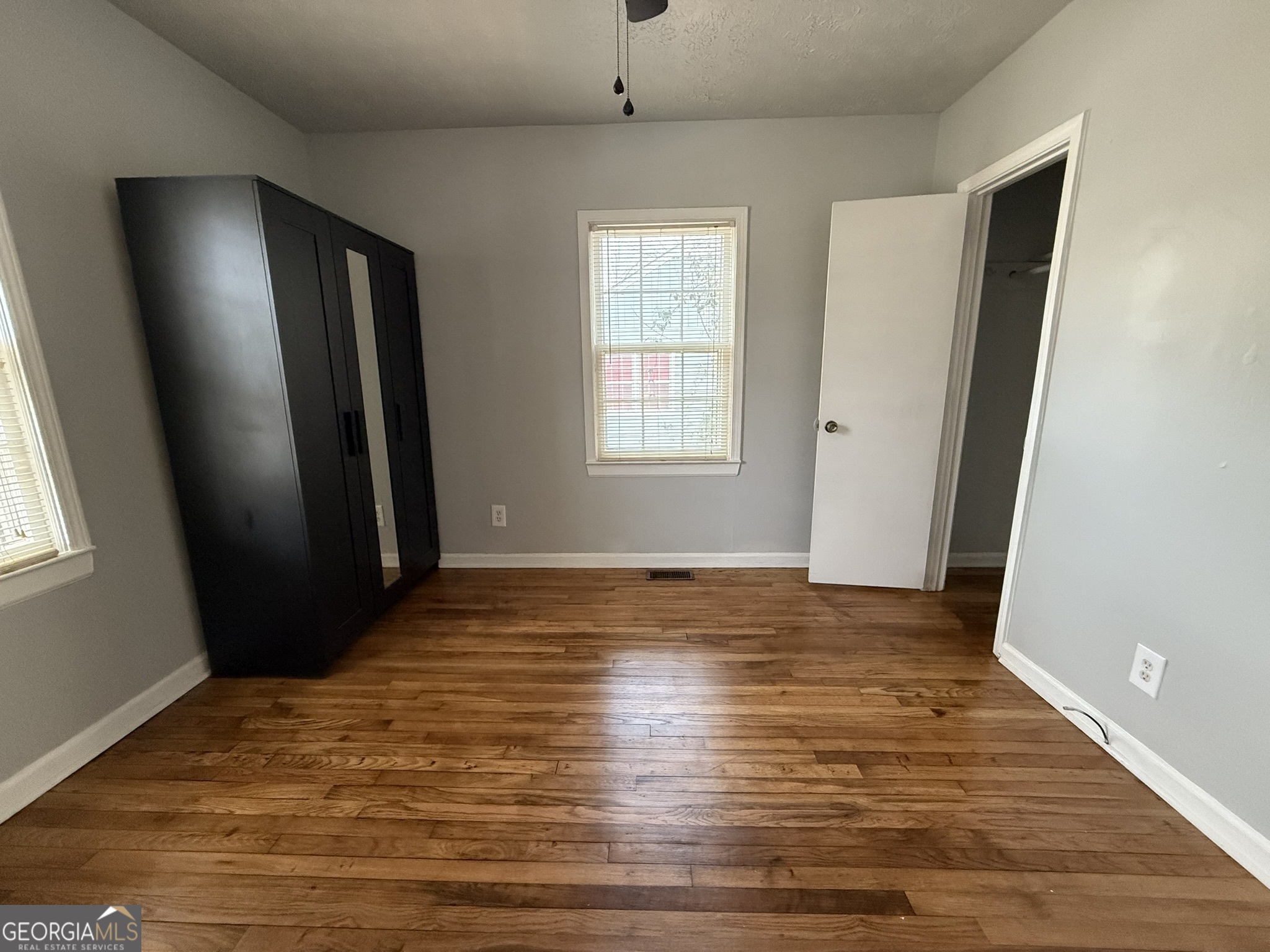 1624 Terry Mill Road Southeast Atlanta, GA 30316 - Photo 9 of 13 a view of an empty room with wooden floor and a window