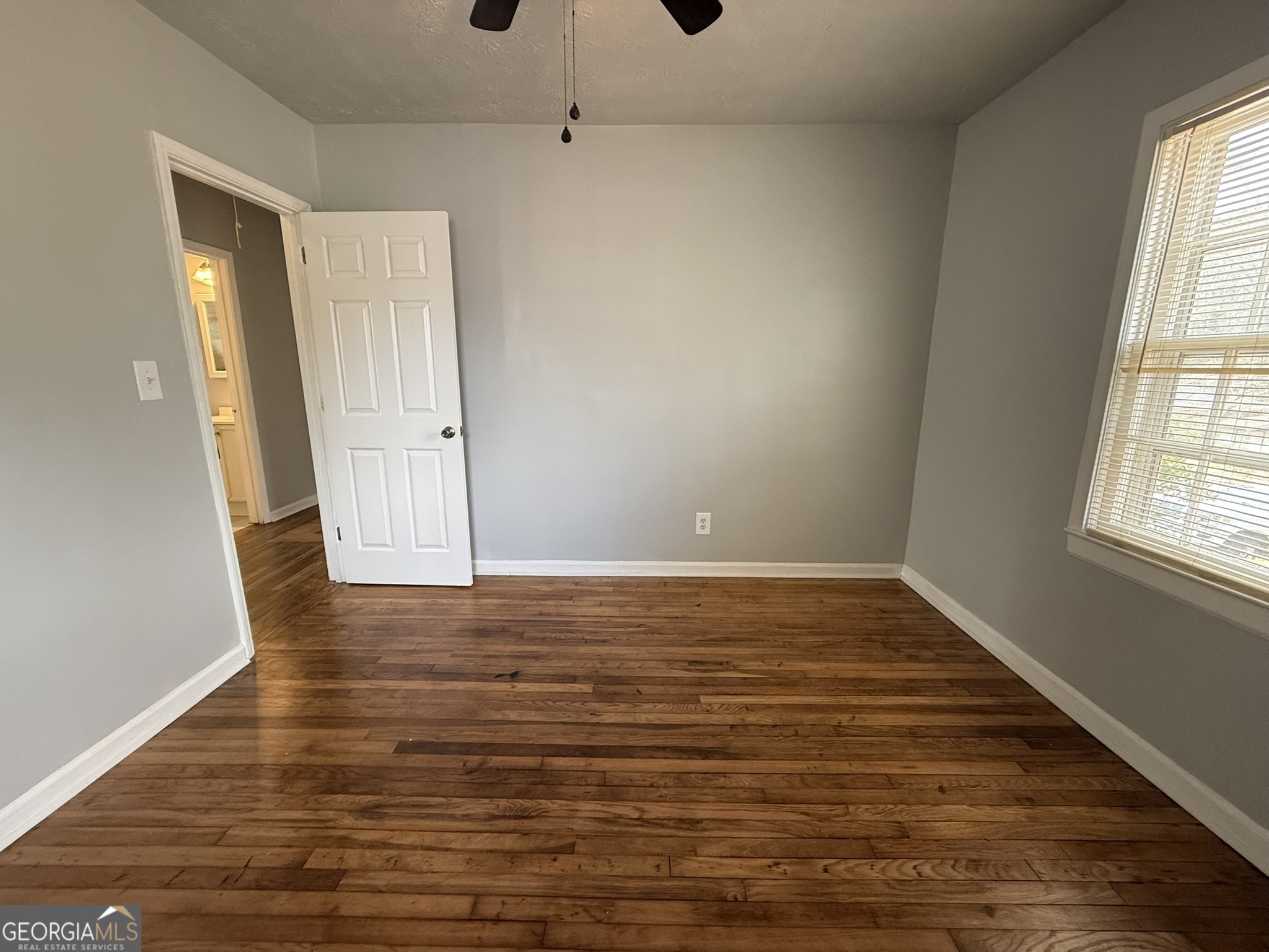 1624 Terry Mill Road Southeast Atlanta, GA 30316 - Photo 10 of 13 a view of an empty room with wooden floor and window