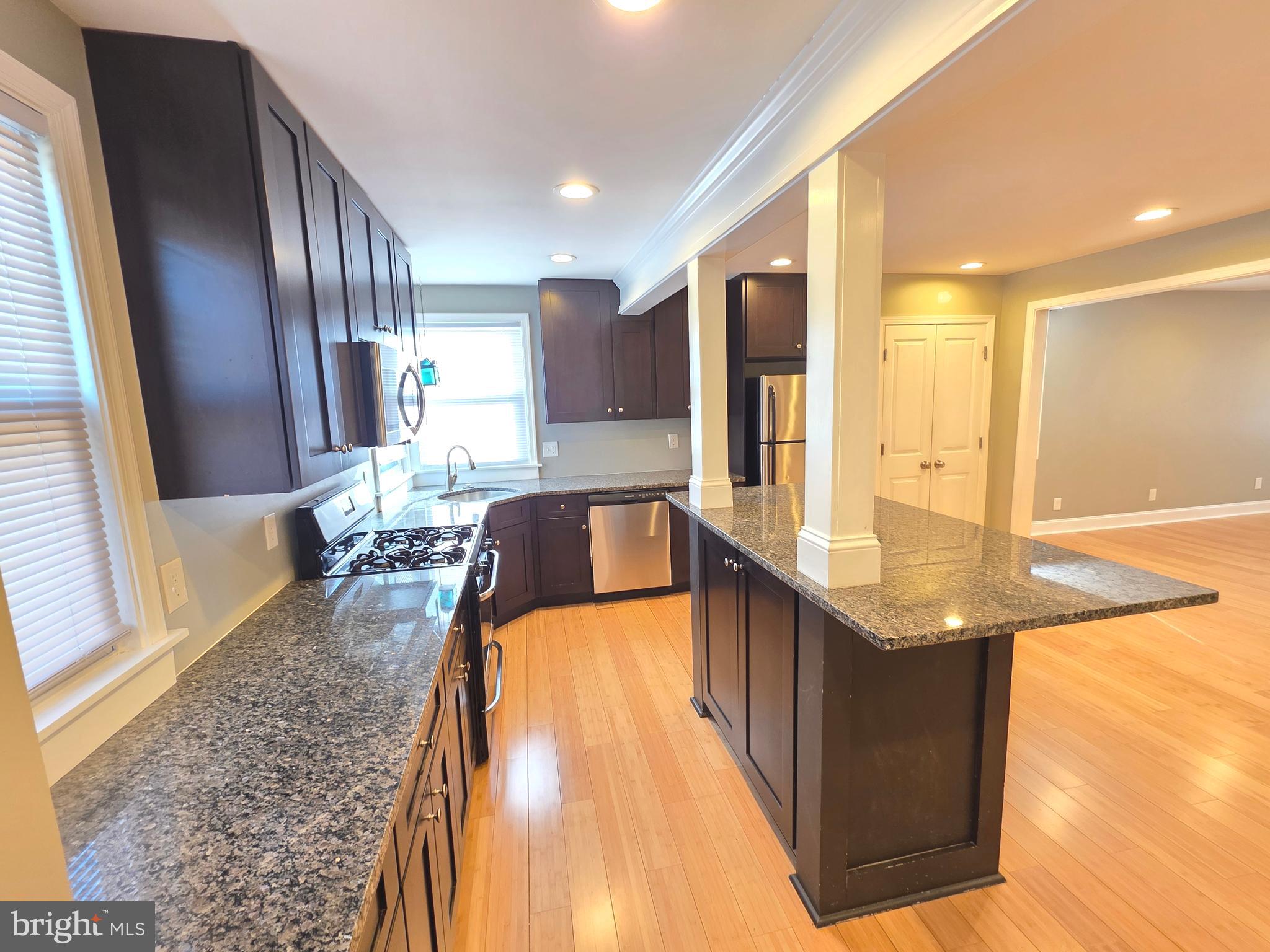 27 Goldy Drive Gloucester City, NJ 08030 - Photo 15 of 41 a spacious bathroom with a granite countertop sink and a large mirror