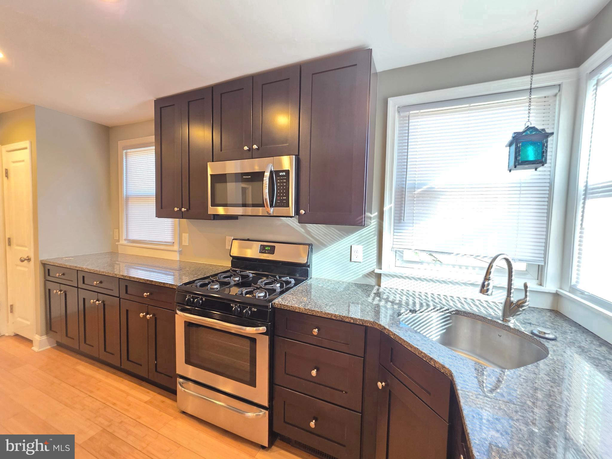 27 Goldy Drive Gloucester City, NJ 08030 - Photo 17 of 41 a kitchen with granite countertop stainless steel appliances a stove sink and cabinets