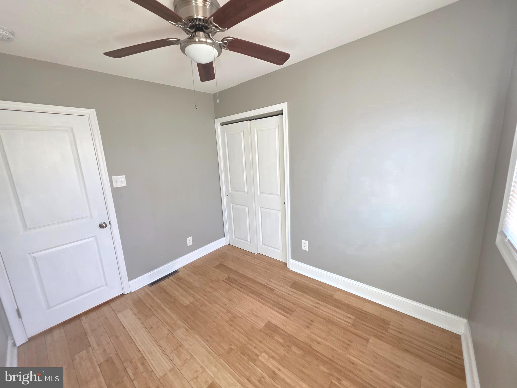 27 Goldy Drive Gloucester City, NJ 08030 - Photo 18 of 41 an empty room with wooden floor and fan