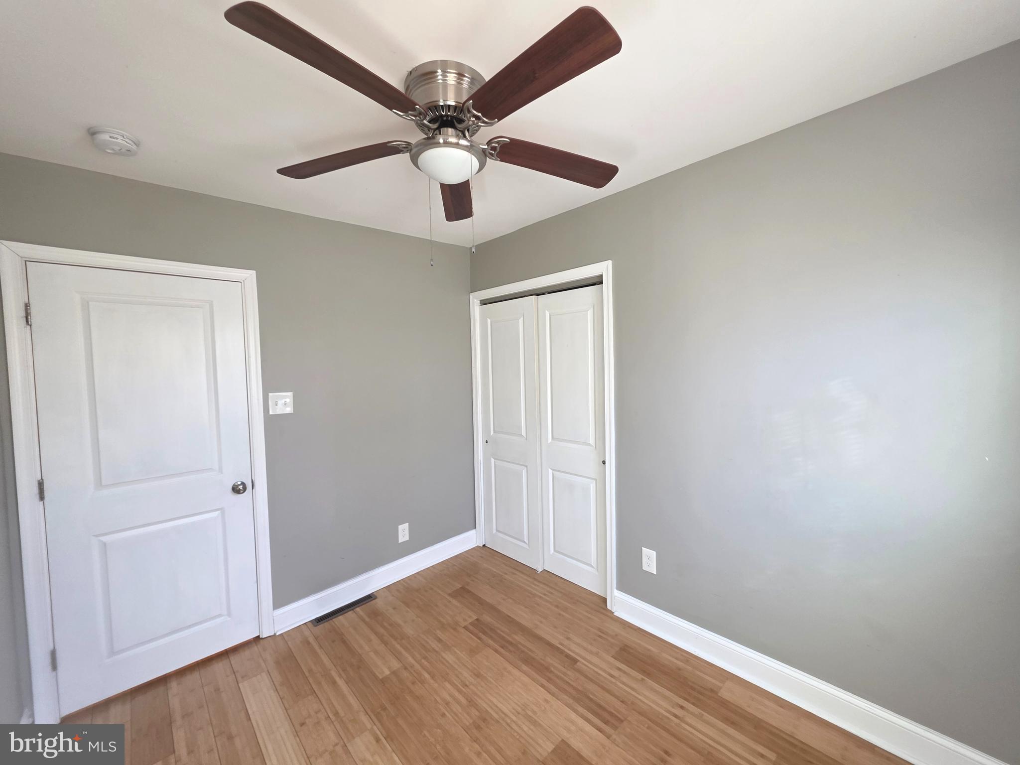 27 Goldy Drive Gloucester City, NJ 08030 - Photo 19 of 41 an empty room with wooden floor and ceiling fan