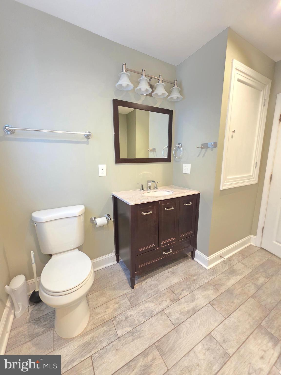 27 Goldy Drive Gloucester City, NJ 08030 - Photo 28 of 41 a bathroom with a toilet a sink and mirror