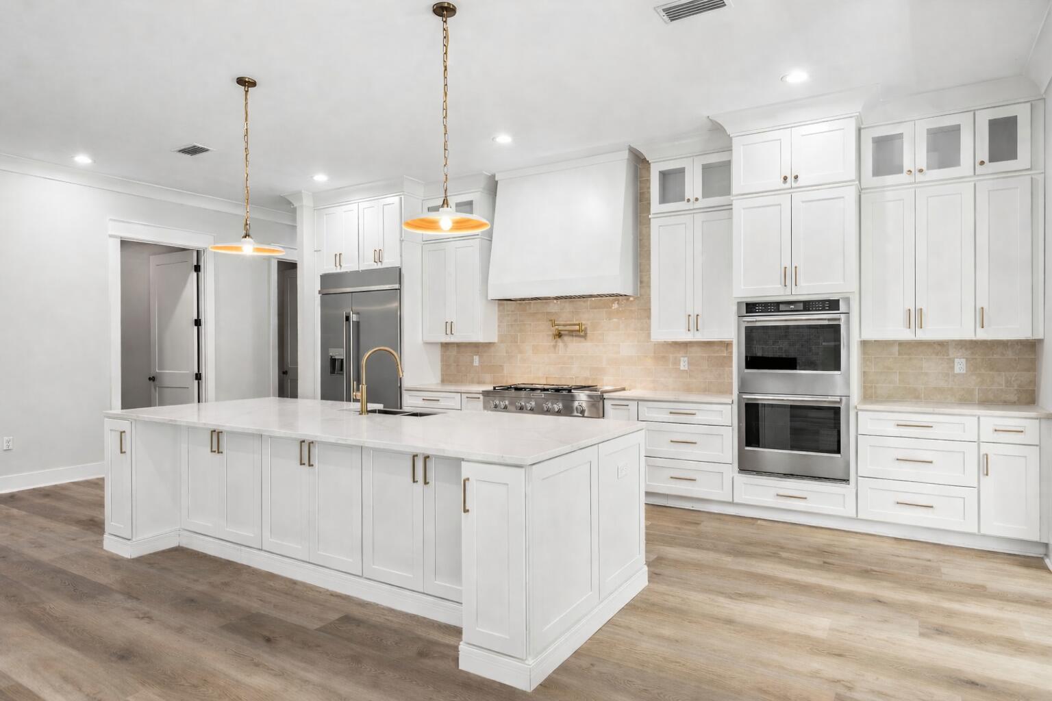 112 East Captain Fritz Way Freeport, FL 32439 - Photo 11 of 114 a kitchen with stainless steel appliances granite countertop a stove a sink and a refrigerator