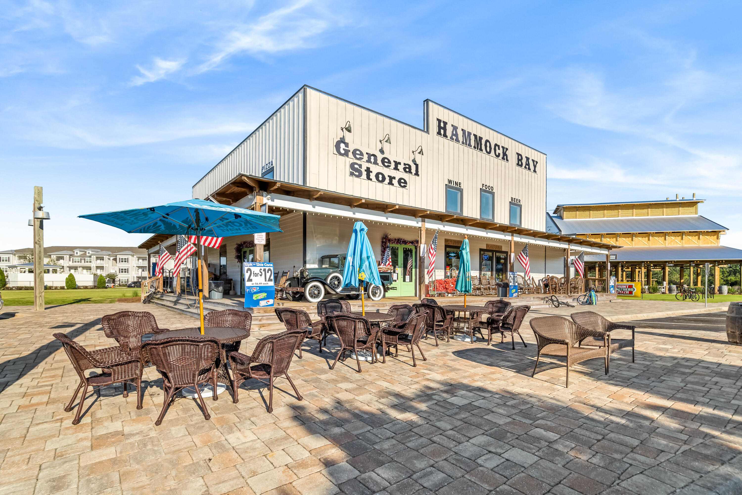 112 East Captain Fritz Way Freeport, FL 32439 - Photo 112 of 114 a group of lawn chairs under an umbrella in front of building