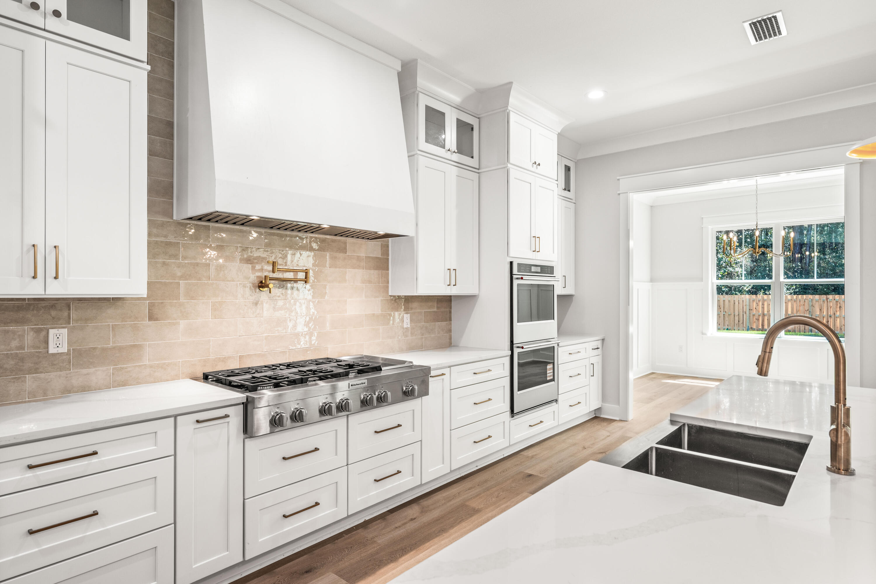 112 East Captain Fritz Way Freeport, FL 32439 - Photo 12 of 114 a kitchen with granite countertop a stove and white cabinets