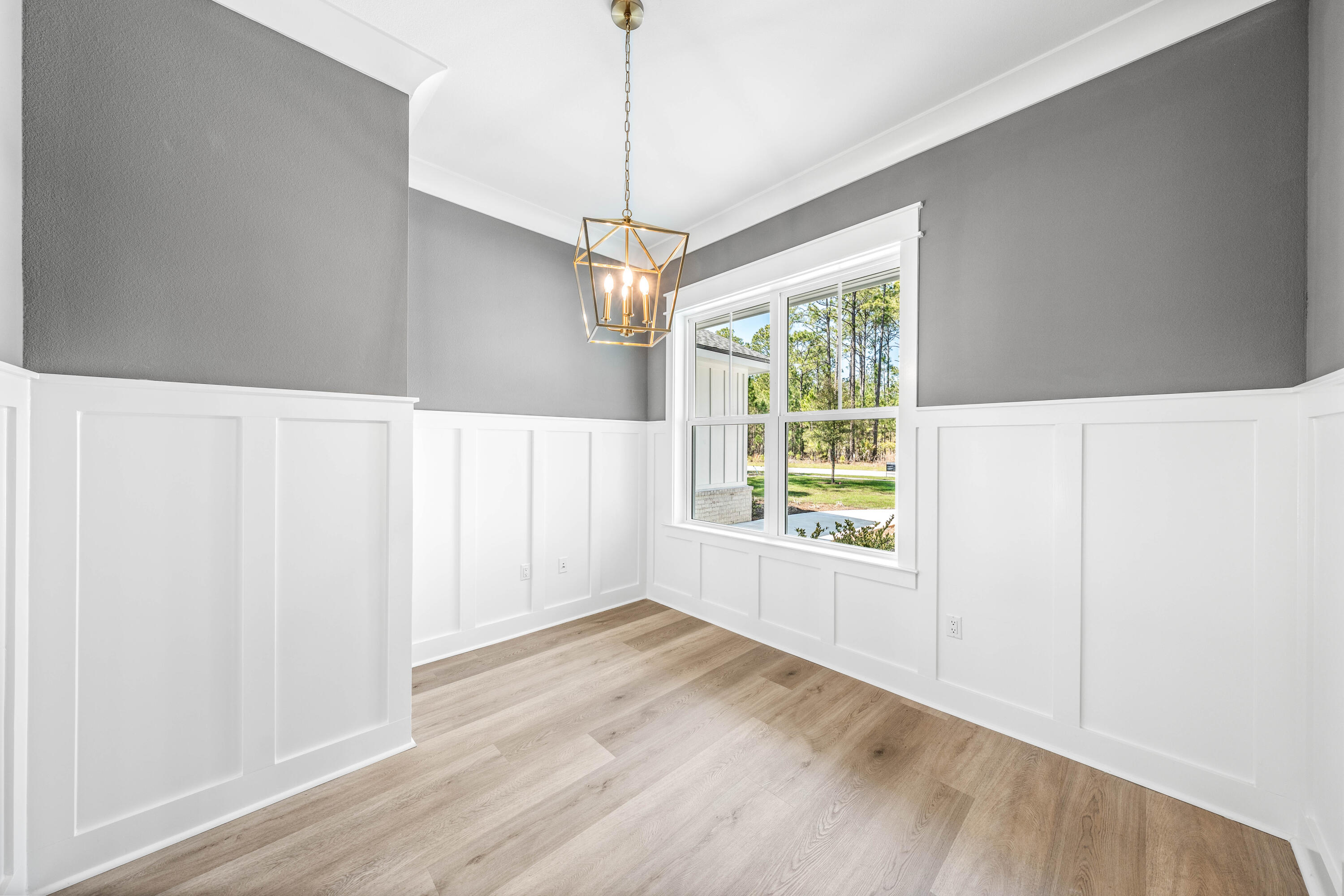 112 East Captain Fritz Way Freeport, FL 32439 - Photo 19 of 114 a view of a kitchen with wooden floor a ceiling fan and windows