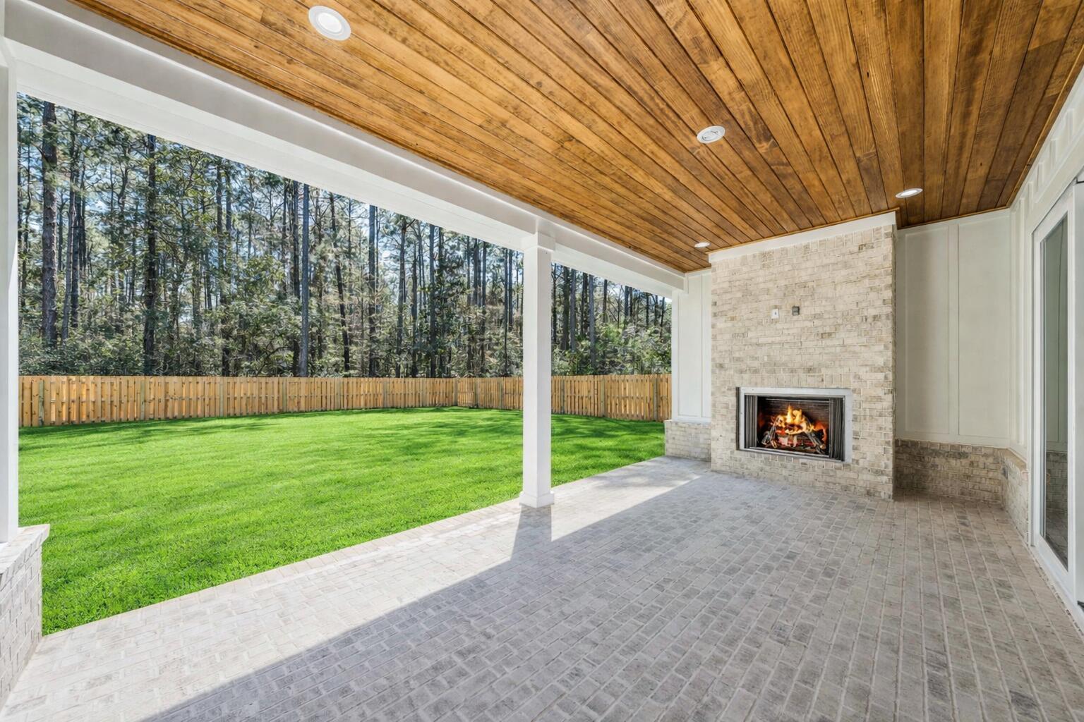 112 East Captain Fritz Way Freeport, FL 32439 - Photo 3 of 114 a view of a porch with a yard fire pit and furniture