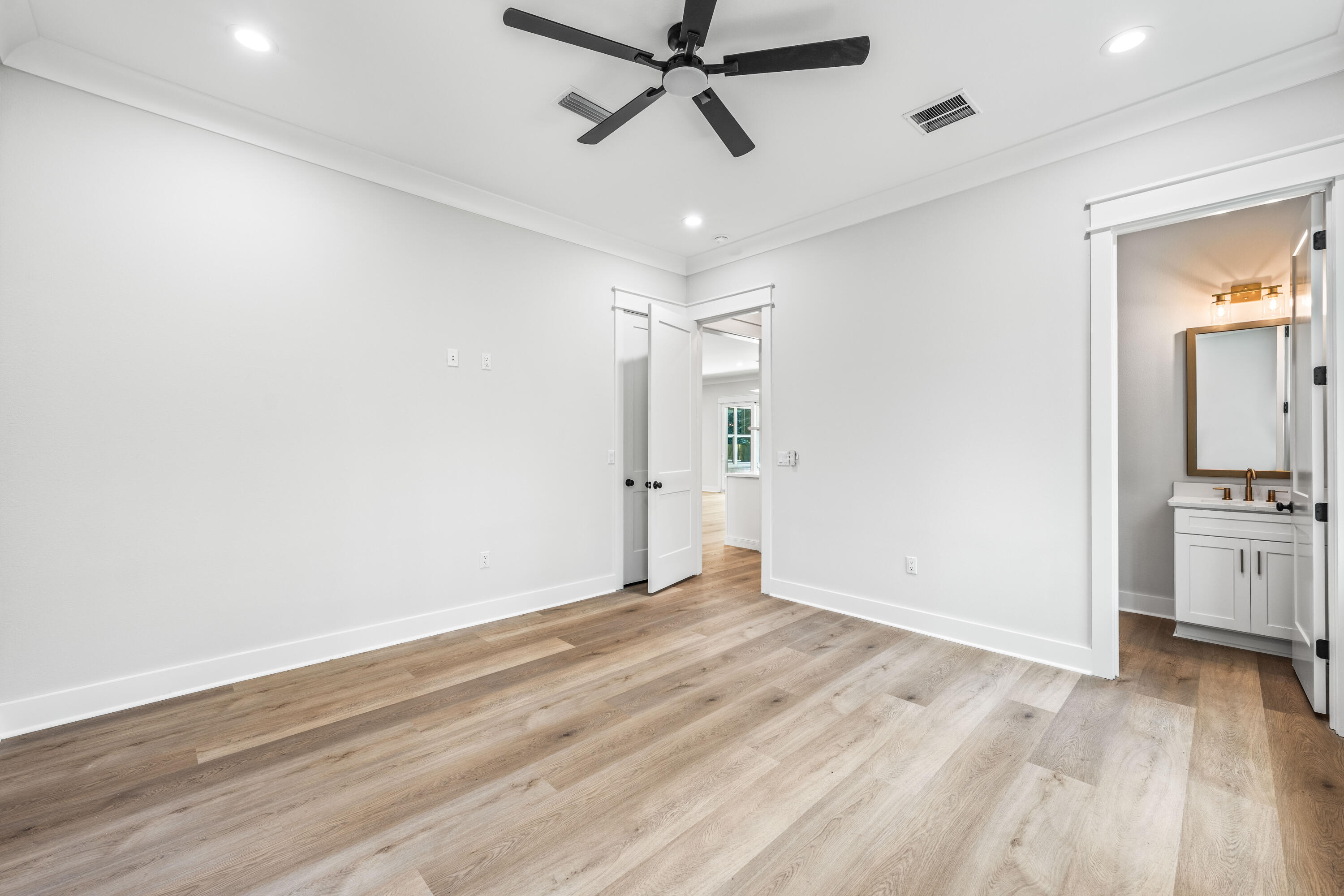 112 East Captain Fritz Way Freeport, FL 32439 - Photo 35 of 114 a view of empty room with wooden floor and ceiling fan