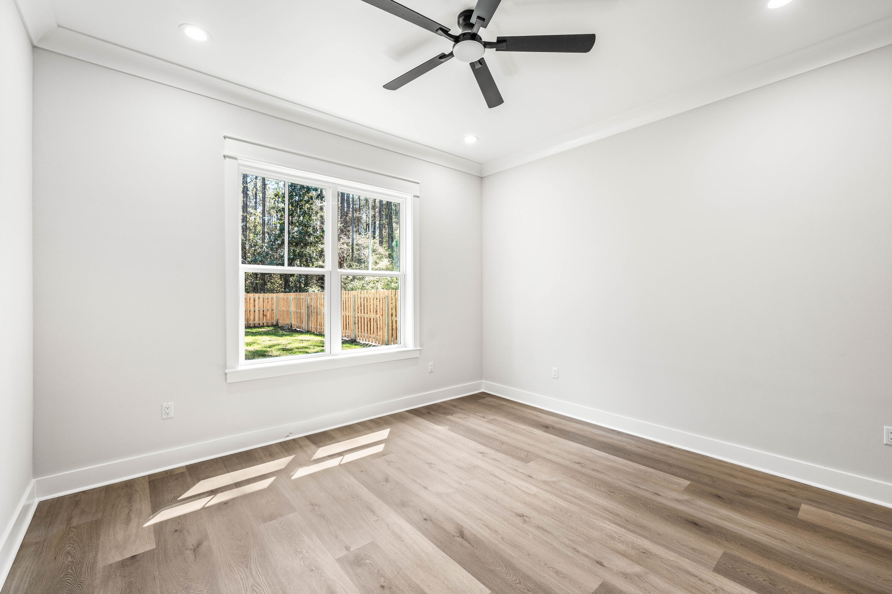 112 East Captain Fritz Way Freeport, FL 32439 - Photo 38 of 114 an empty room with a window and a fan