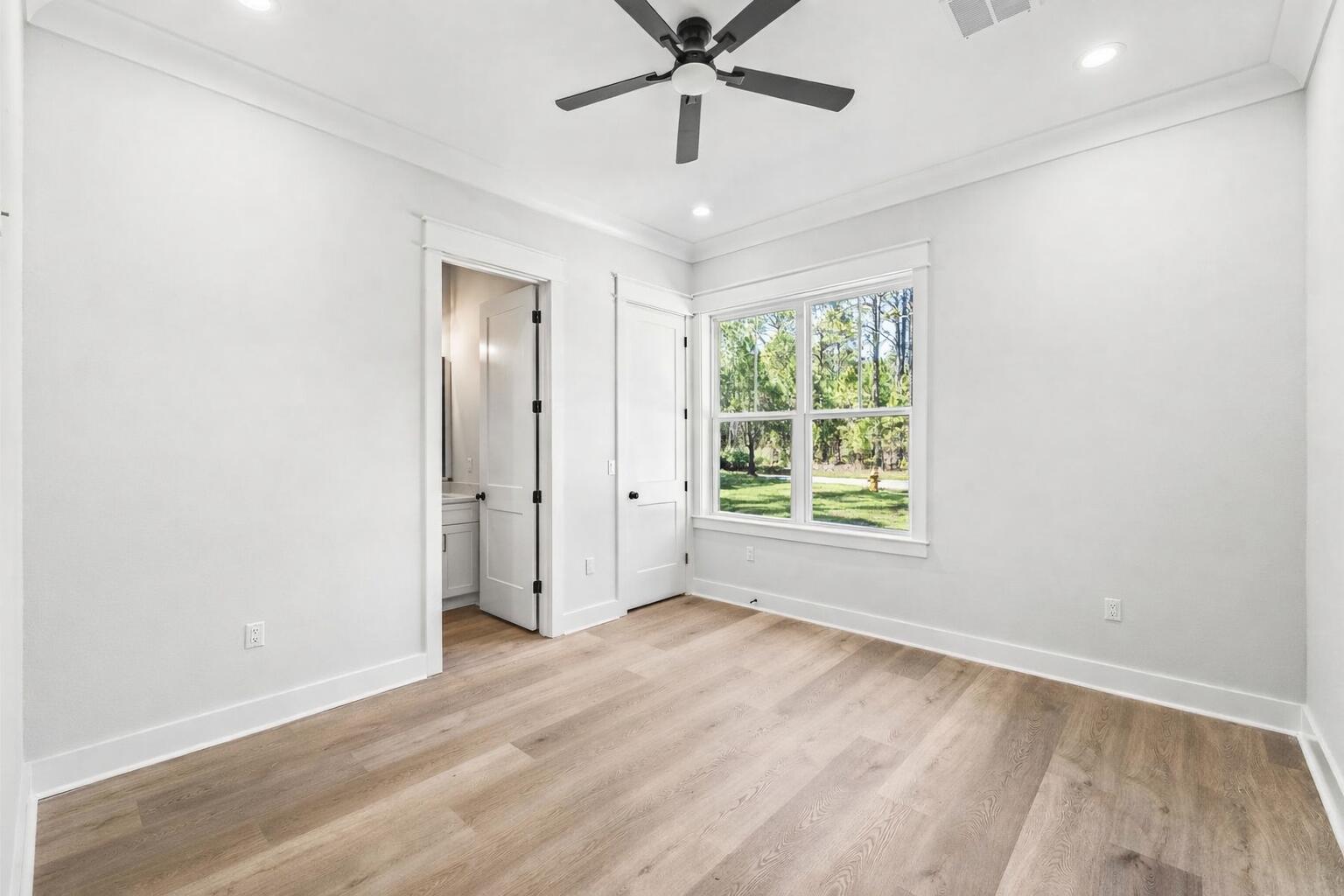 112 East Captain Fritz Way Freeport, FL 32439 - Photo 43 of 114 wooden floor in an empty room with a window